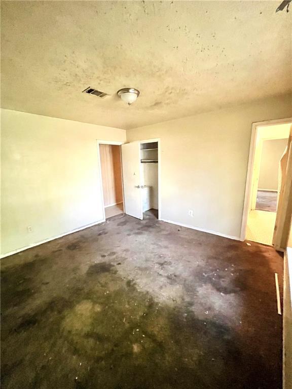 hall with tile patterned floors