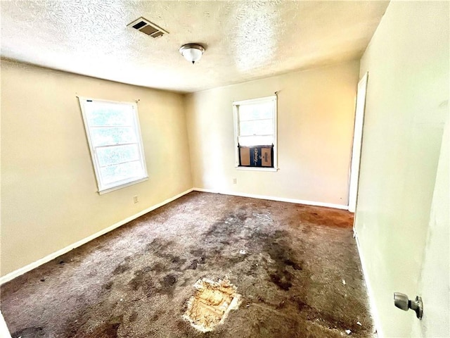 spare room featuring a textured ceiling