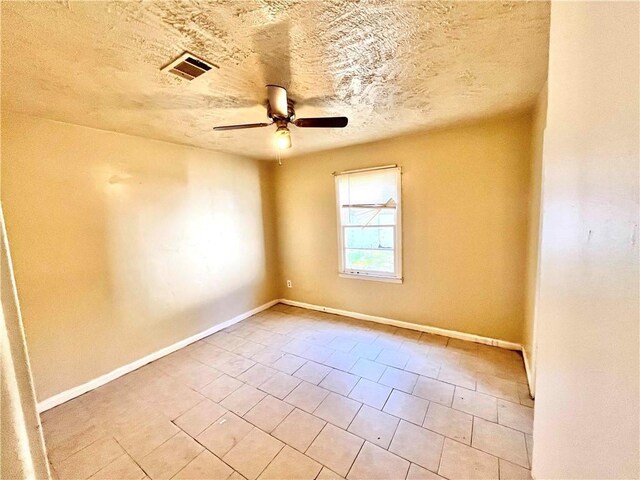 unfurnished bedroom featuring ceiling fan, ensuite bath, a textured ceiling, and light tile patterned floors