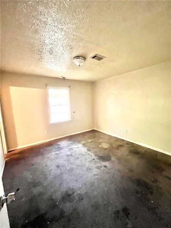 entrance foyer featuring a textured ceiling, ceiling fan, and light tile patterned flooring