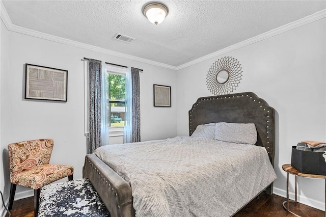 bedroom with dark wood-style floors, visible vents, ornamental molding, and a textured ceiling