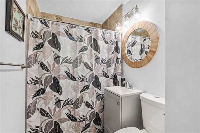 bathroom with toilet, a textured ceiling, vanity, and a shower with shower curtain