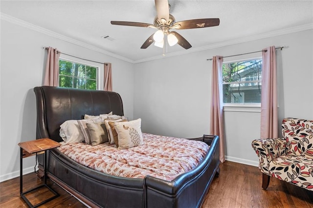 bedroom featuring wood finished floors, ornamental molding, and multiple windows
