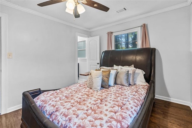 bedroom with crown molding, a ceiling fan, wood finished floors, and baseboards