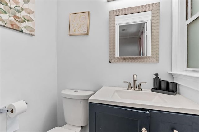 bathroom with toilet and vanity
