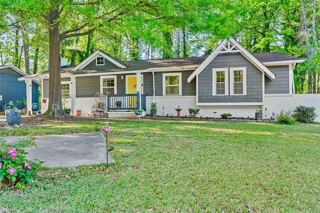 single story home with brick siding, a porch, and a front lawn