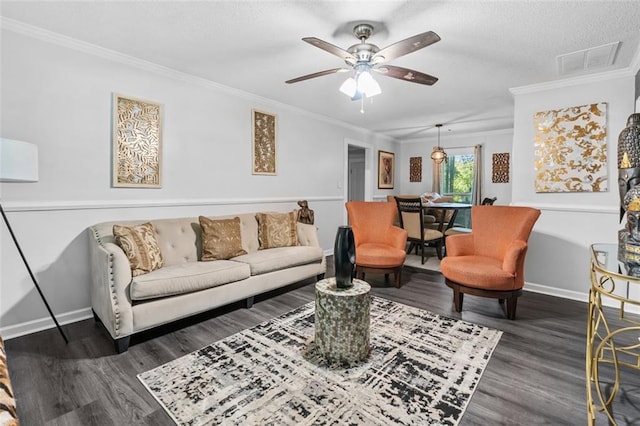 living room featuring baseboards, visible vents, wood finished floors, and a ceiling fan