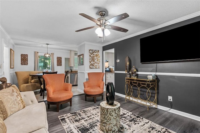 living room featuring baseboards, a ceiling fan, dark wood-style flooring, and crown molding