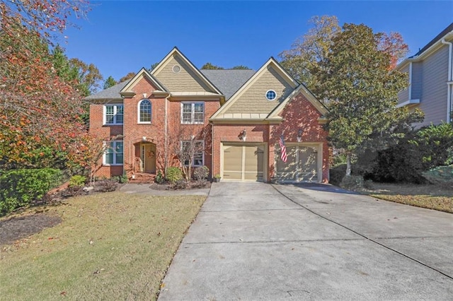 view of front of home with a front yard and a garage