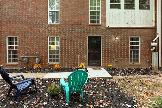 view of exterior entry with a patio