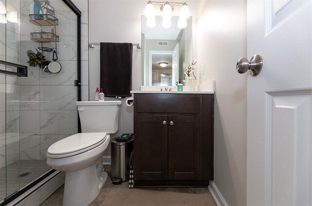 bathroom with walk in shower, vanity, and toilet