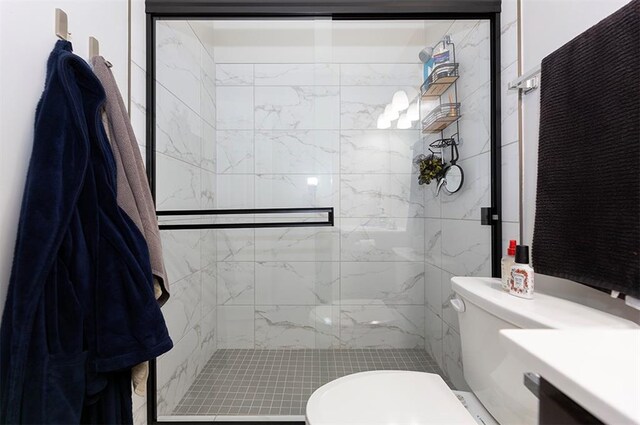 bathroom featuring toilet and a shower with shower door