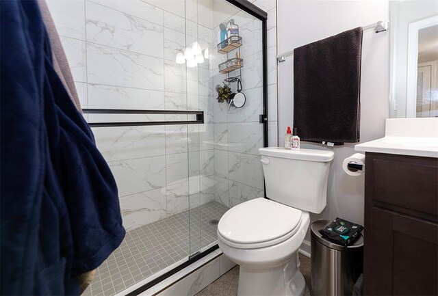 bathroom featuring vanity, toilet, and an enclosed shower