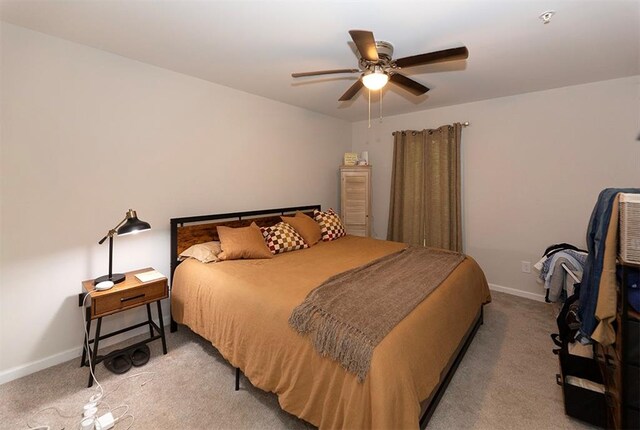 bedroom with ceiling fan and light carpet