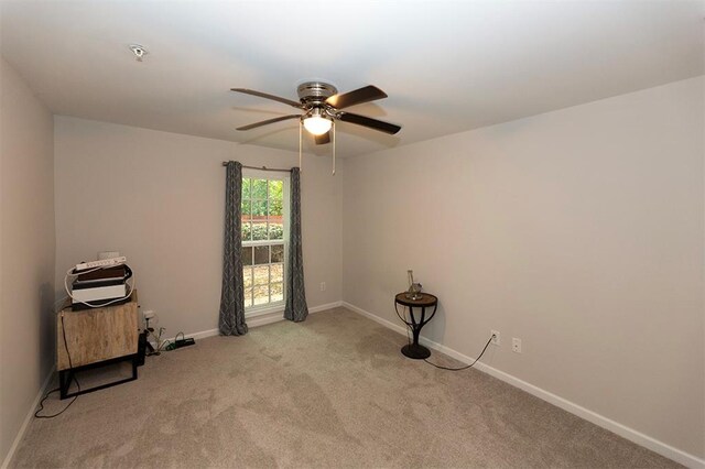 unfurnished room featuring light carpet and ceiling fan