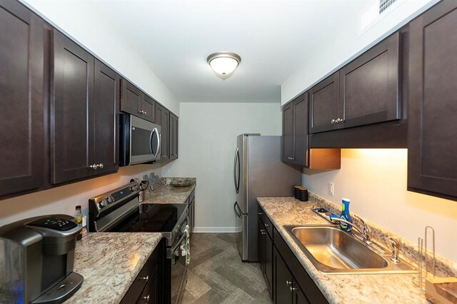 kitchen featuring dark brown cabinetry, stainless steel appliances, and sink