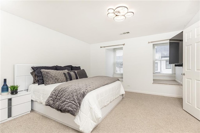 bedroom with carpet floors, baseboards, and visible vents