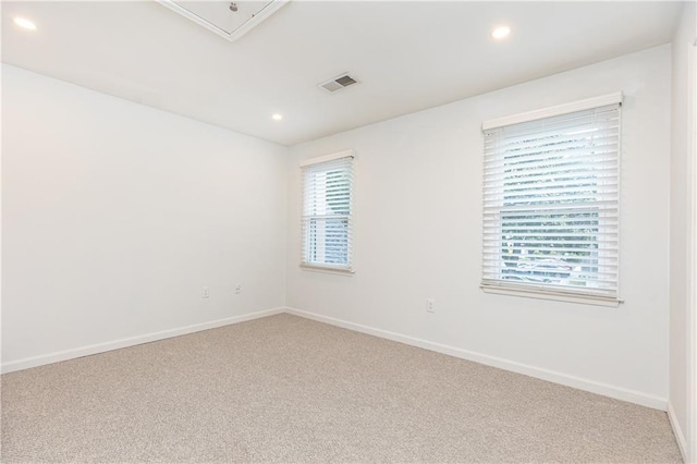 carpeted empty room with baseboards, recessed lighting, and visible vents