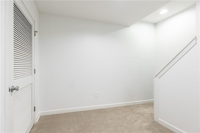 interior space with baseboards, recessed lighting, and light colored carpet