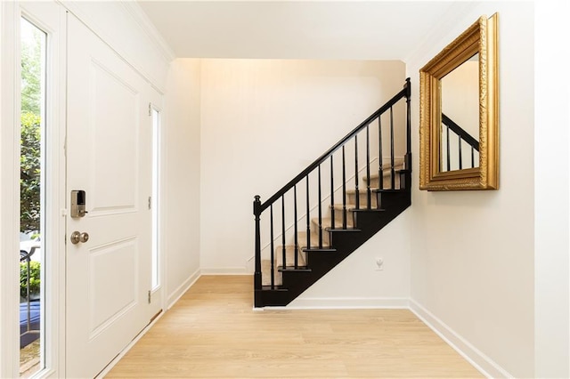 entryway with baseboards, stairs, and wood finished floors
