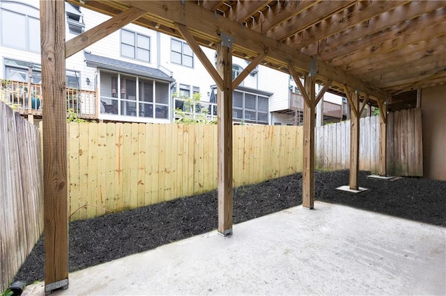 view of patio / terrace featuring a fenced backyard and a sunroom