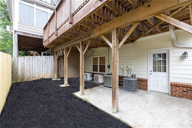 view of patio featuring central air condition unit, fence, and ac unit