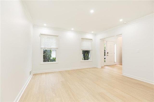 spare room featuring recessed lighting, baseboards, ornamental molding, and light wood finished floors