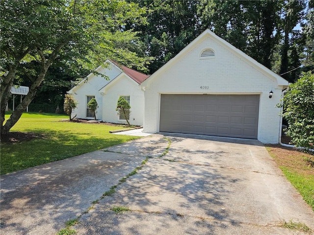 view of front of home with a garage and a front lawn