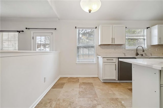 kitchen featuring white cabinetry, dishwasher, tasteful backsplash, and a wealth of natural light