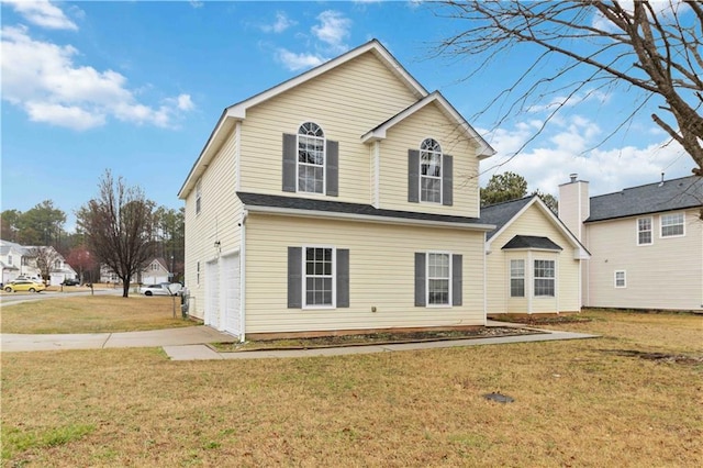 exterior space with a garage and a front lawn