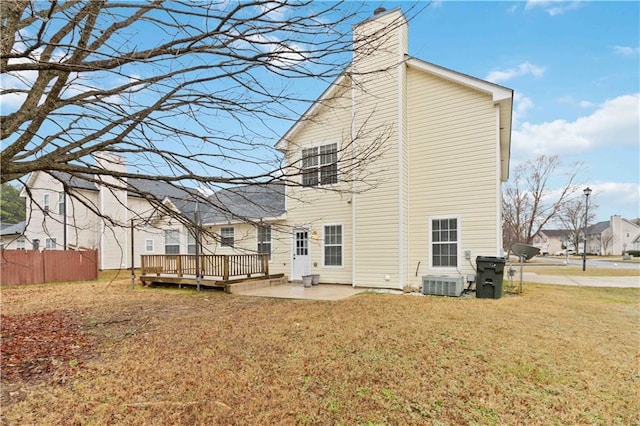 rear view of house with a wooden deck, central AC unit, a patio area, and a lawn