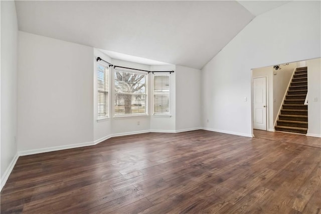 unfurnished room featuring dark hardwood / wood-style flooring and vaulted ceiling