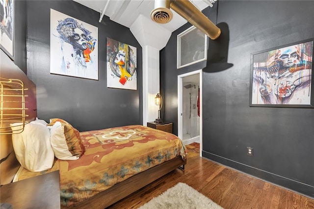 bedroom featuring hardwood / wood-style flooring, vaulted ceiling, and ceiling fan