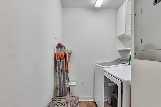 laundry room featuring cabinets and washer and clothes dryer