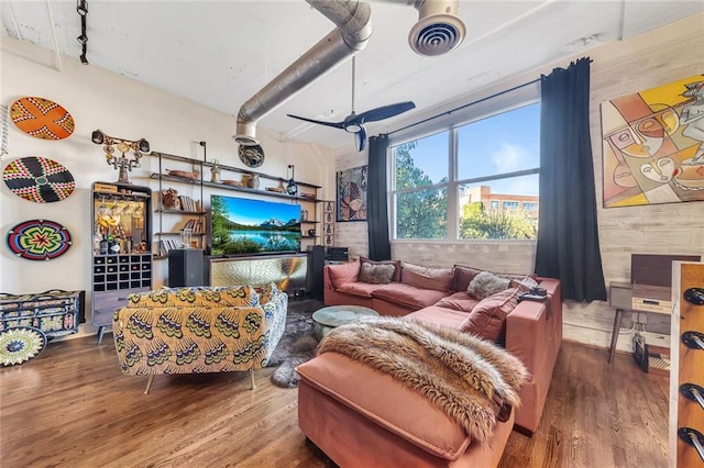 living room featuring wood-type flooring and wooden walls