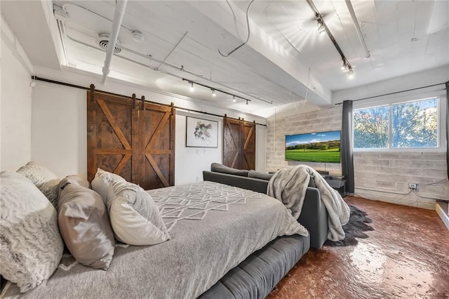 bedroom with a barn door and rail lighting