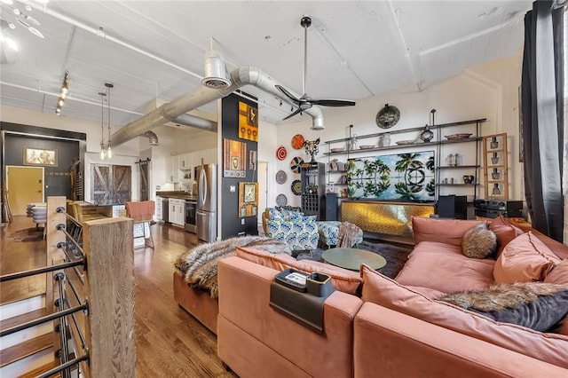 living room featuring hardwood / wood-style floors and ceiling fan