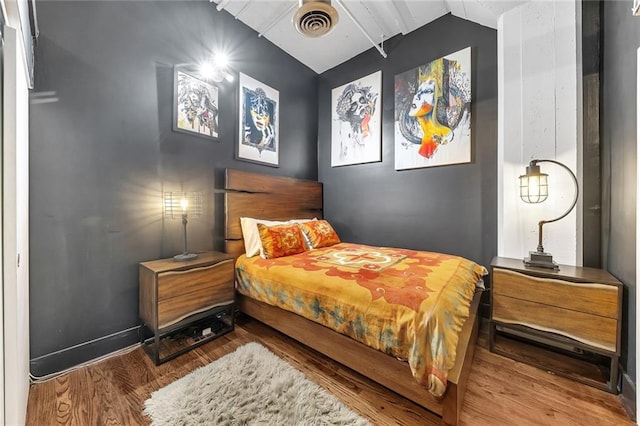 bedroom with hardwood / wood-style floors, ceiling fan, and lofted ceiling