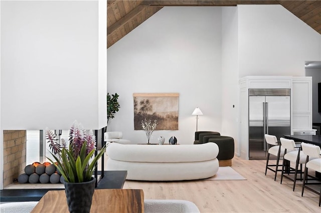 living room featuring light hardwood / wood-style flooring, high vaulted ceiling, and wood ceiling