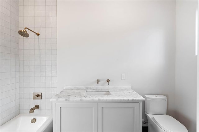 full bathroom featuring vanity, toilet, and tiled shower / bath combo