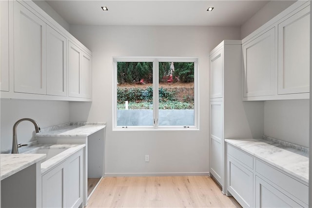 washroom featuring sink and light hardwood / wood-style floors