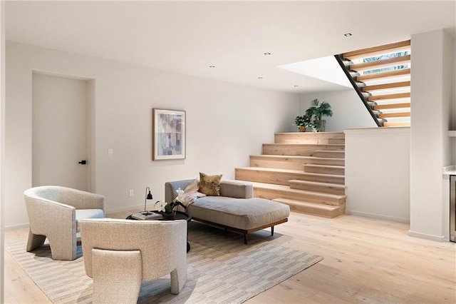 living area featuring light wood-type flooring and wine cooler