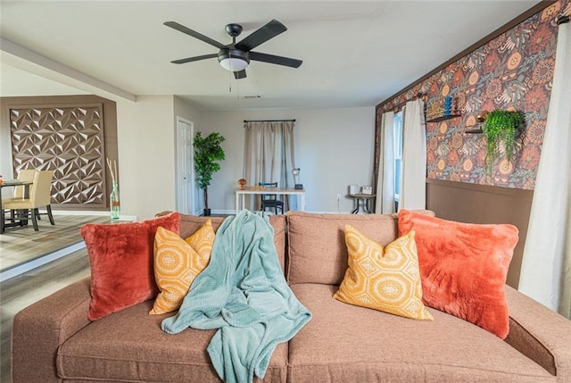 living area featuring visible vents and ceiling fan