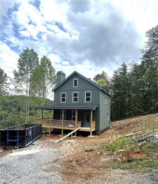 1374 Foxhound Trl NE, Ranger, GA 30734 - rustic home featuring board and batten siding, a chimney, a deck, and a porch