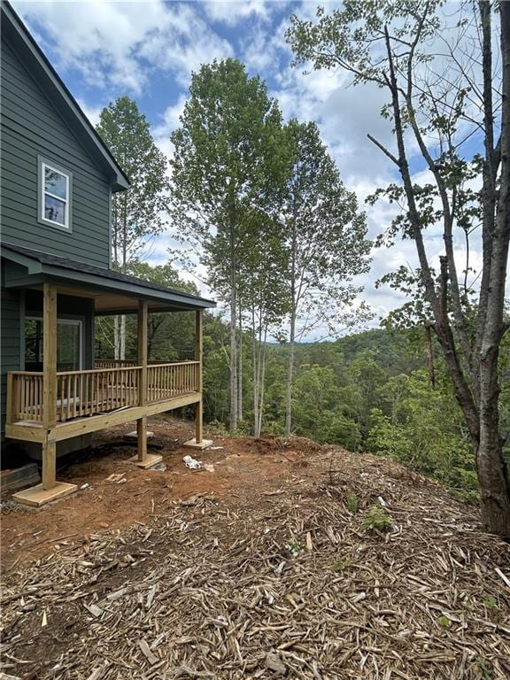 1374 Foxhound Trl NE, Ranger, GA 30734 - view of yard with a wooden deck and a wooded view