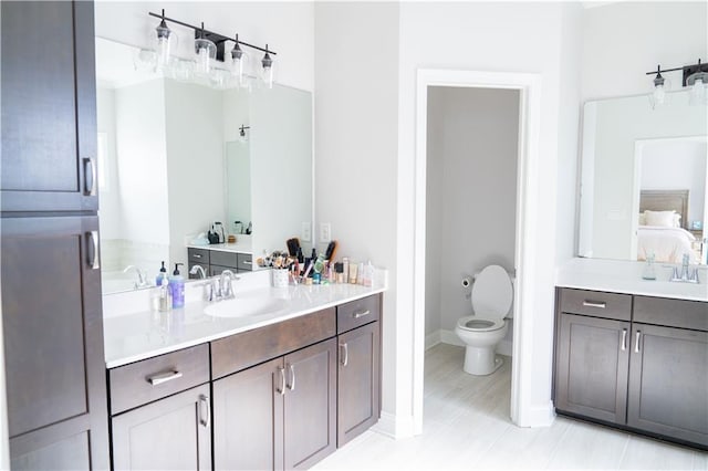 bathroom featuring vanity, toilet, and ensuite bathroom