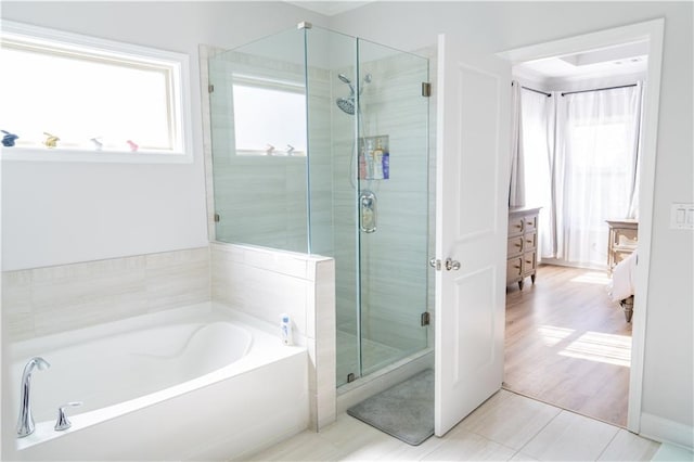 bathroom featuring a shower stall and a garden tub