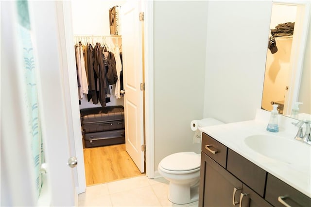 bathroom with vanity, tile patterned floors, and toilet