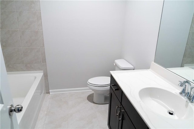 full bathroom featuring tile patterned floors, toilet, a tub to relax in, baseboards, and vanity