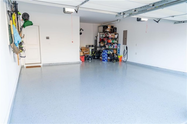 garage featuring electric panel, baseboards, and a garage door opener